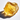 Large translucent yellow citrine gemstone sharp natural facets resting on a white surface, highlighting its warm golden hue and reflective clarity.