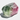  Large rough multicoloured tourmaline crystal with vivid green‑to‑pink color zoning and natural striations, highlighting its translucent raw mineral texture and striking gemstone contrast.