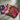 Three small patterned fabric bags laid side by side, featuring purple crescent motifs, a red and pink geometric star design, and a maroon floral print on a flat surface. Designed and made by Nas Mode.